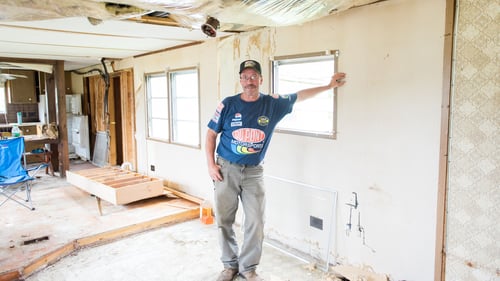 A contractor works on repairs to a manufactured home.