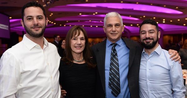 Michael Swack with his wife and sons in colorful ballroom