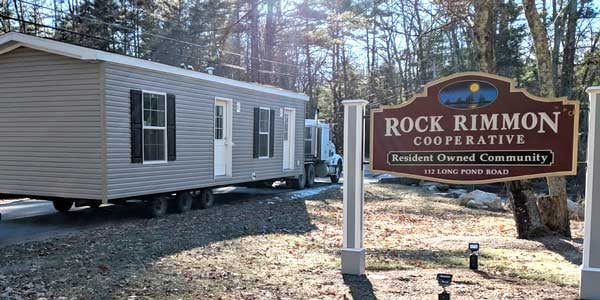 A manufactured home is hauled into Rock Rimmon Cooperative